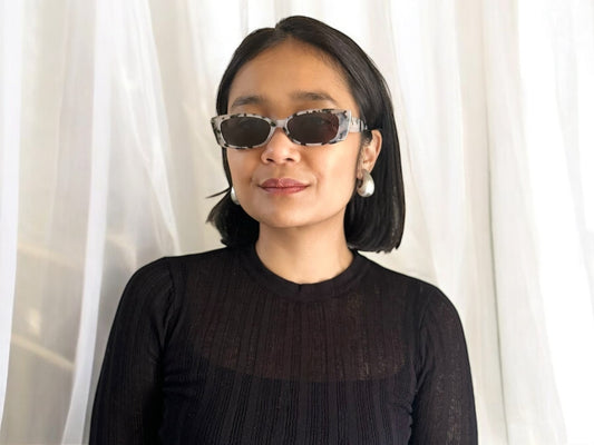 Model wearing Rata Rectangular Polarised Acetate Sunglasses in Tortoiseshell, posing against a neutral background.