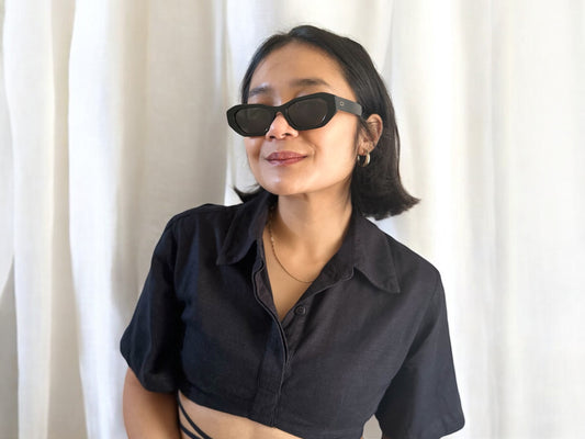 Model wearing Sofia Polarised Acetate Sunglasses in Black with a black top, posing against a neutral background.